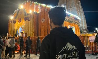 Devotee at illuminated Kedarnath Temple night