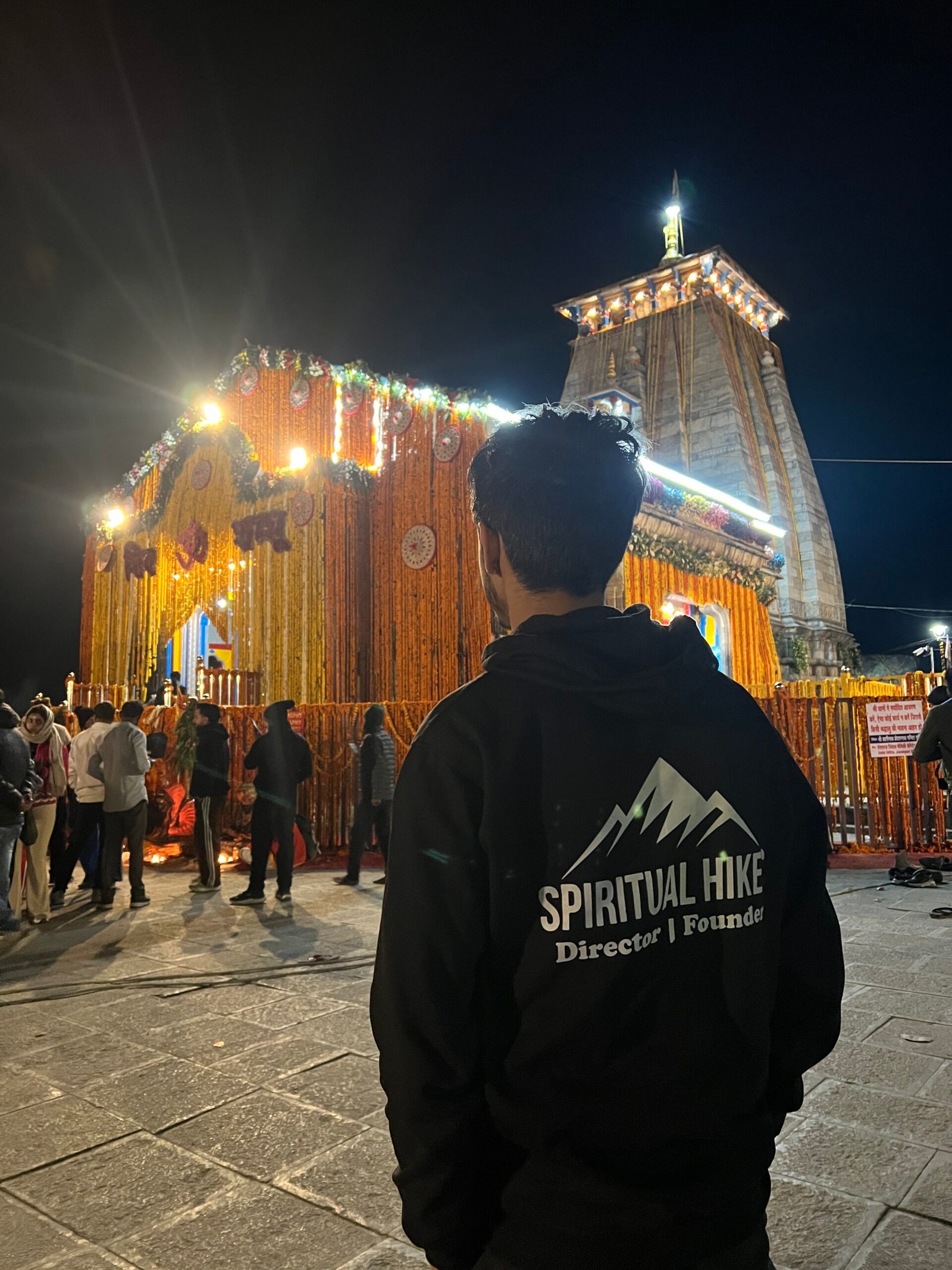 Devotee at illuminated Kedarnath Temple night