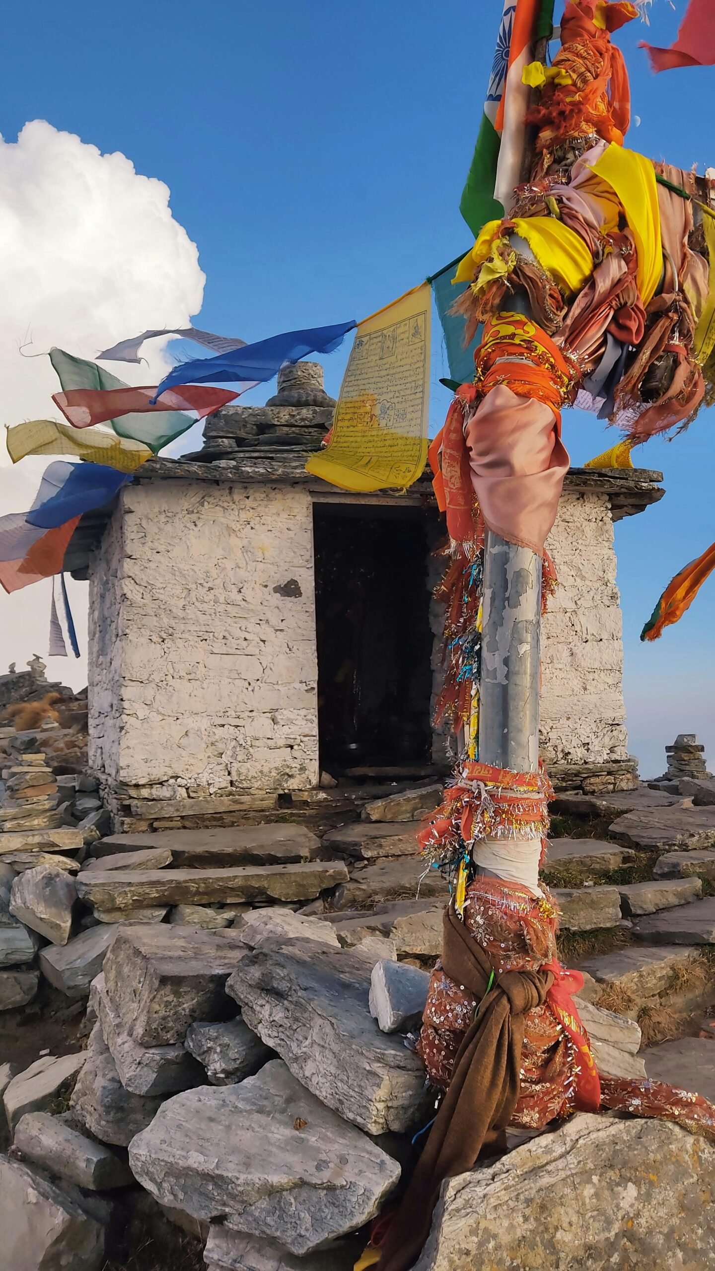 Mountain shrine with colorful prayer flags
